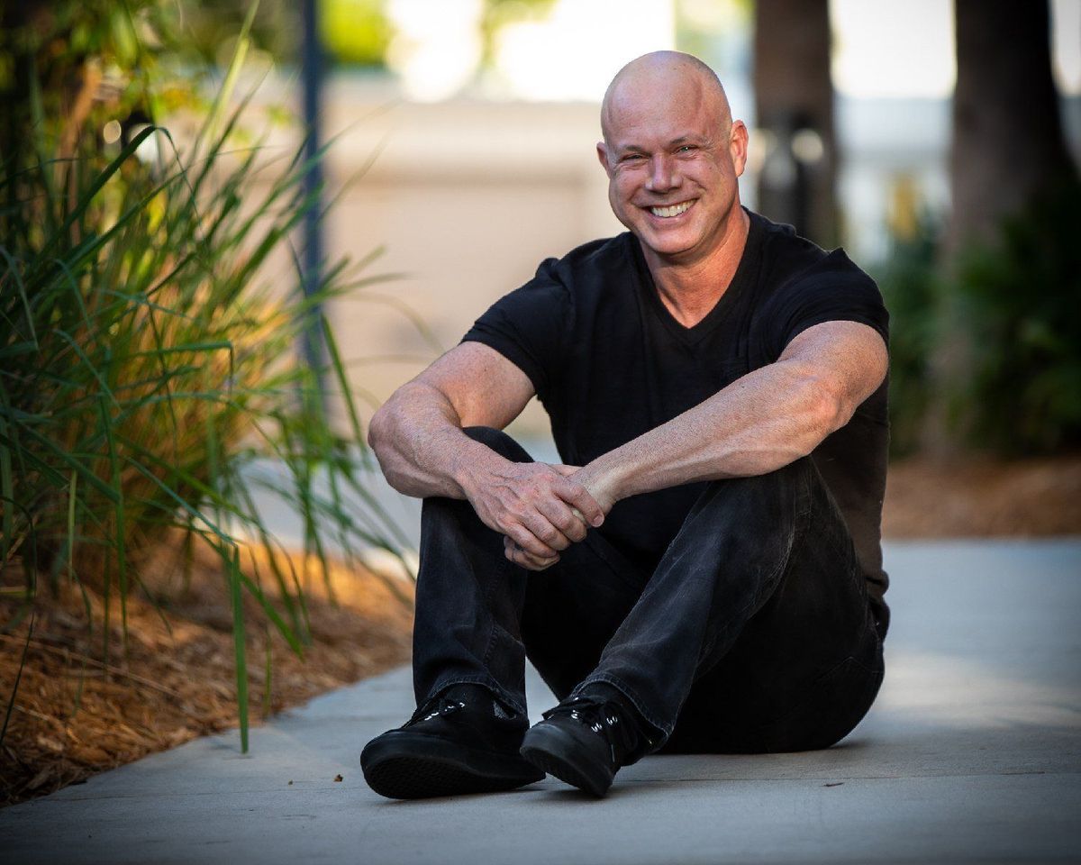 Shawn Huber, mental wellness coach for high achievers, sitting outdoors